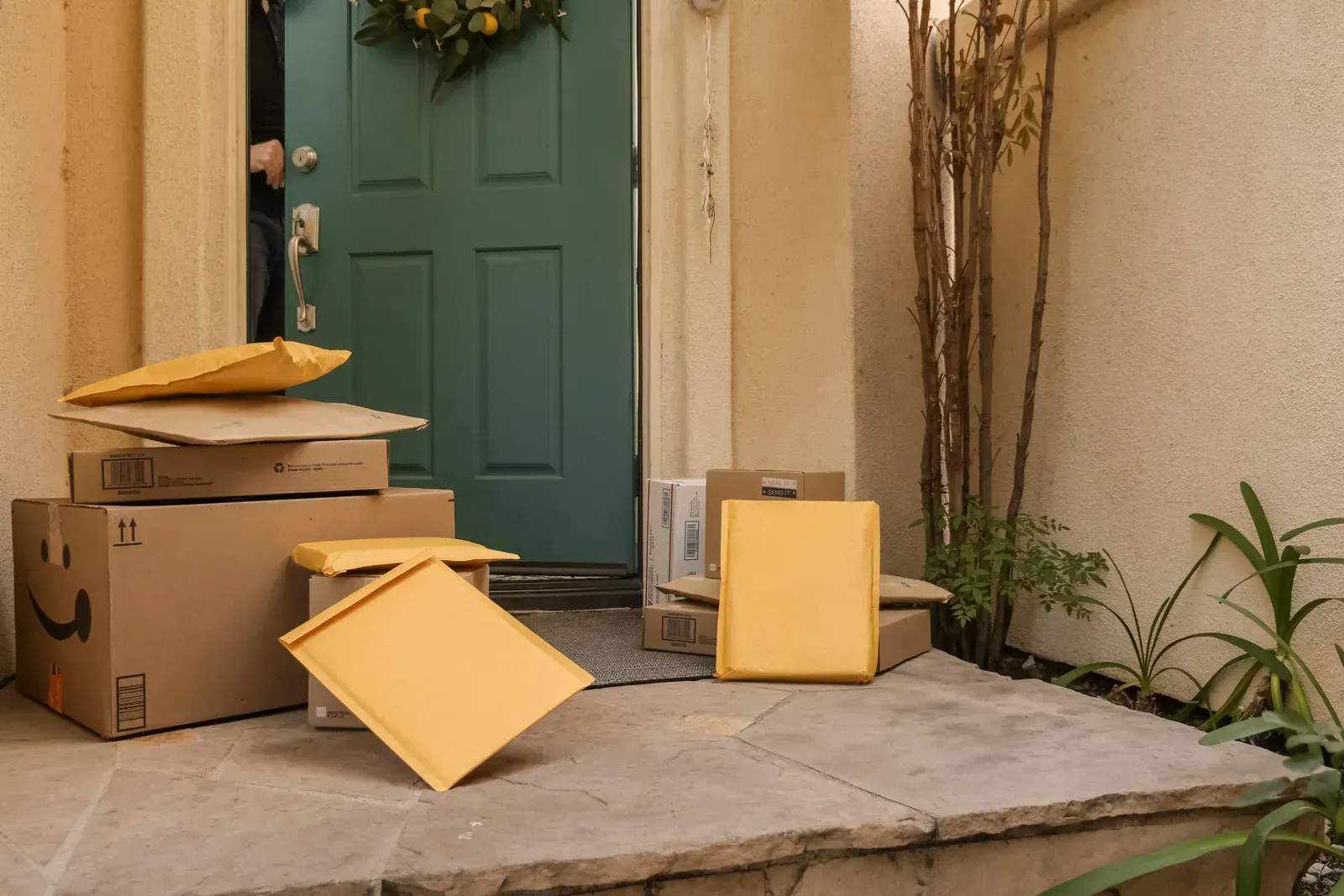 Delivery boxes stacked at a teal front door, how both subscription filters and bulk multipacks arrive