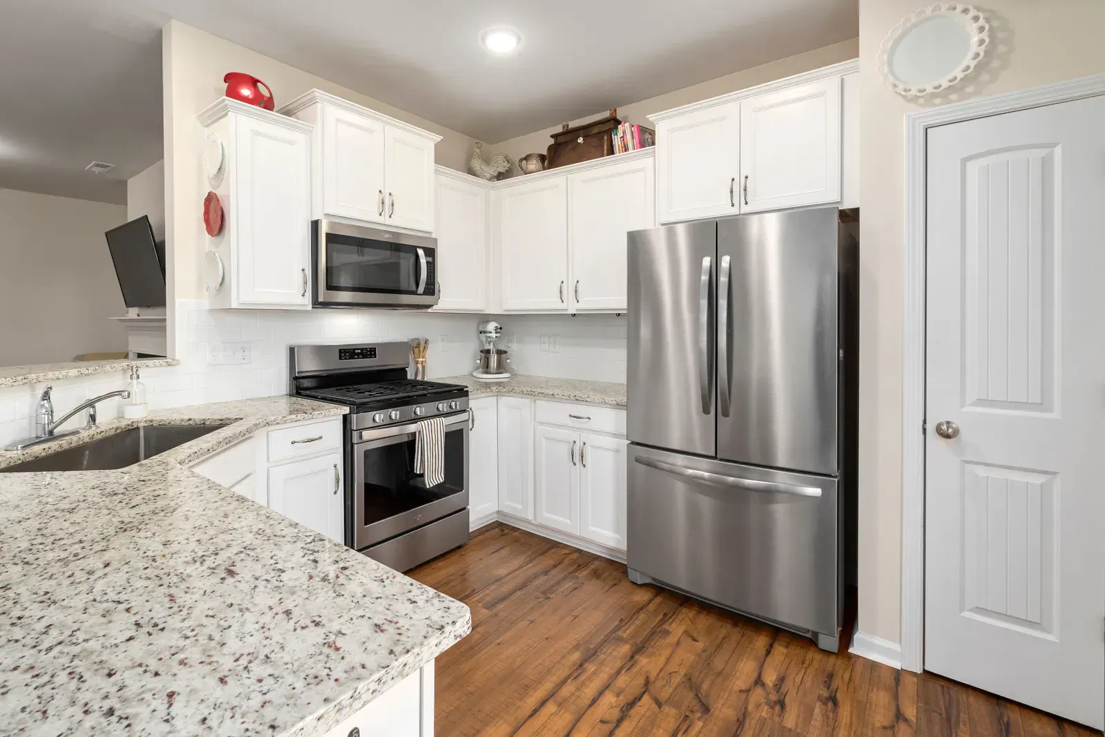 Stainless steel refrigerator in a bright white kitchen, the appliance every replacement filter has to match