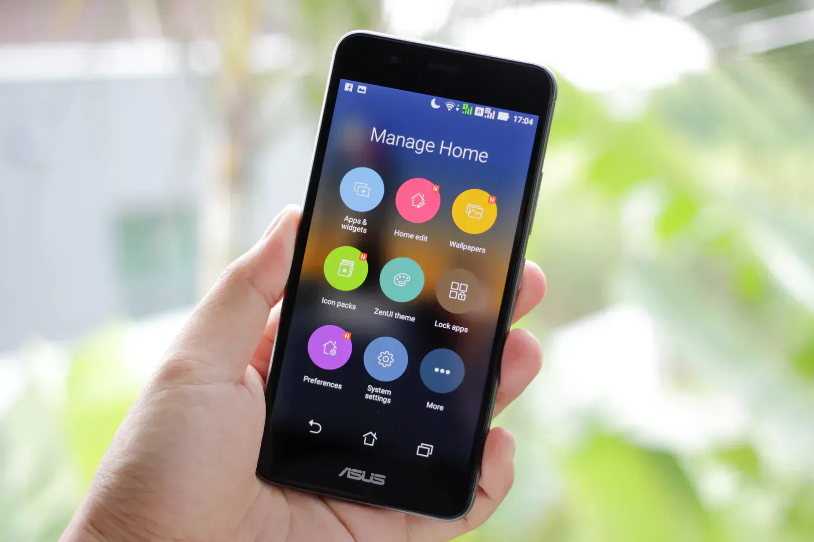 Hand holding a smartphone with home control apps, the way a smart leak detector reaches you away from the house
